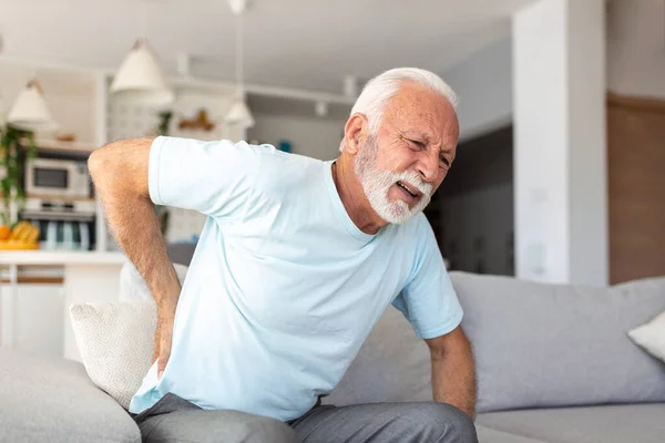 stock image Senior elderly man touching his back, suffering from backpain, sciatica, sedentary lifestyle concept. Spine health problems. Healthcare, insurance