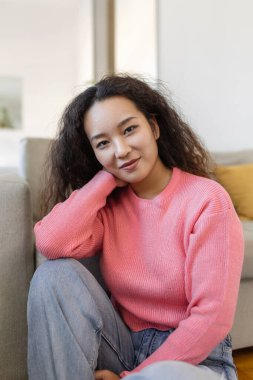 Portrait of beautiful young Asian woman looking at camera. Beautiful woman smiling at home.