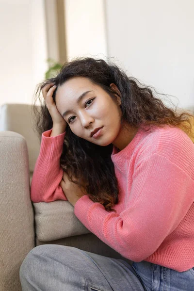 Portrait of beautiful young Asian woman looking at camera. Beautiful woman smiling at home.