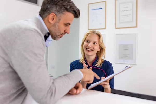 Male Visitor Filling Out Medicine Documents Doctor Office Patient Asking — Stock Photo, Image