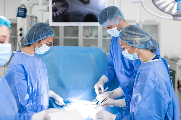 외과의사 간호사 실에서 환자에게 수술을 진행하고 의사들은 악기를 말하고 — 스톡 사진