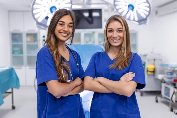 stock image Young female medical professionals standing together. concept of health protection. Successful team of medical doctors are looking at camera and smiling while standing in hospital