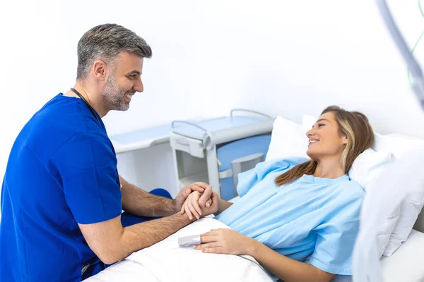 stock image Healthcare concept of professional doctor consulting and comforting patient in hospital bed or counsel diagnosis health. Medical doctor or nurse holding patient's hands and comforting her
