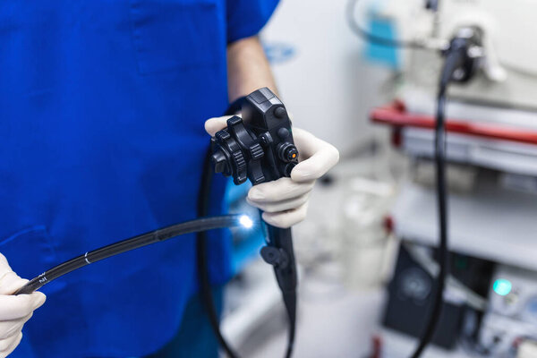 Endoscopy at the hospital. Doctor holding endoscope before gastroscopy. Medical examination