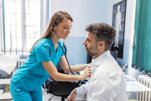 Caring Caucasian Female Doctor Use Phonendoscope Examine Male Patient Heart — Stock Photo, Image