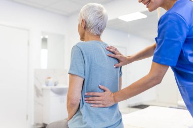 Physiotherapist doing healing treatment on woman's back. Back pain patient, treatment, Doctor consulting with patient Back problems Physical therapy concept clipart