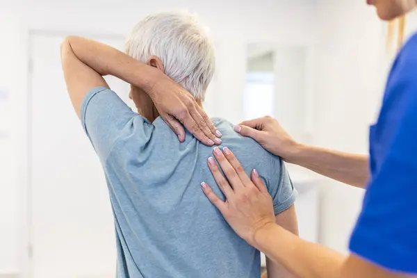 Physiotherapist doing healing treatment on woman\'s back. Back pain patient, treatment, Doctor consulting with patient Back problems Physical therapy concept