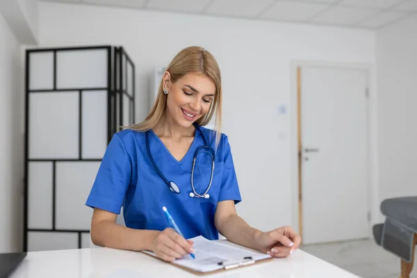 Portrait of female health care professional, doctor, with stethoscope. Portrait of beautiful woman doctor holding digital tablet and looking at camera.