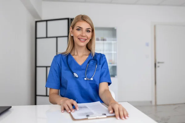 Portrait of female health care professional, doctor, with stethoscope. Portrait of beautiful mature woman doctor holding digital tablet and looking at camera.