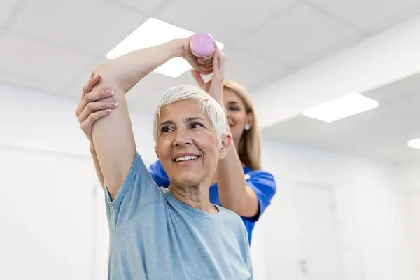 Medical Training Physiotherapy Dumbbell Old Woman Nurse Rehabilitation Support Retirement Royalty Free Stock Images