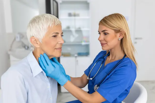 Endocrinologist Examining Throat Senior Woman Clinic Women Thyroid Gland Test Royalty Free Stock Photos