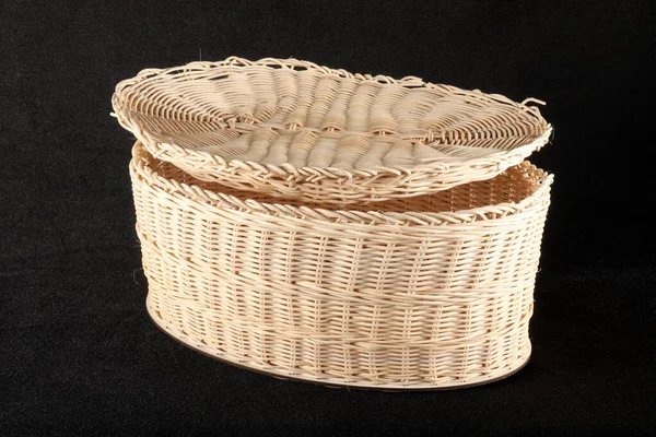 Knitted basket with lid on black background