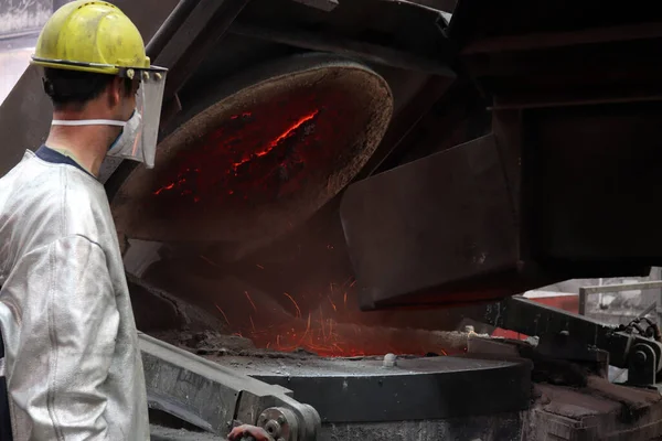 Metal industry work - pouring molten metal