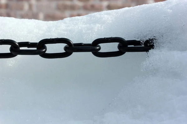 Strong chain in snow close-up