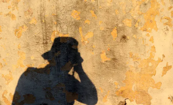 photographer\'s shadow on the wall