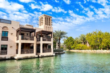 Dubai, Birleşik Arap Emirlikleri - 08 Ocak 2023: Dubai 'deki en ünlü tatil beldesi Madinat Jumeirah' da Arap tarzı binalar, kanallar ve tropikal manzaralı güzel bir lüks otel
