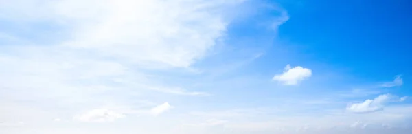 Bright blue sky with clouds in the sunlight