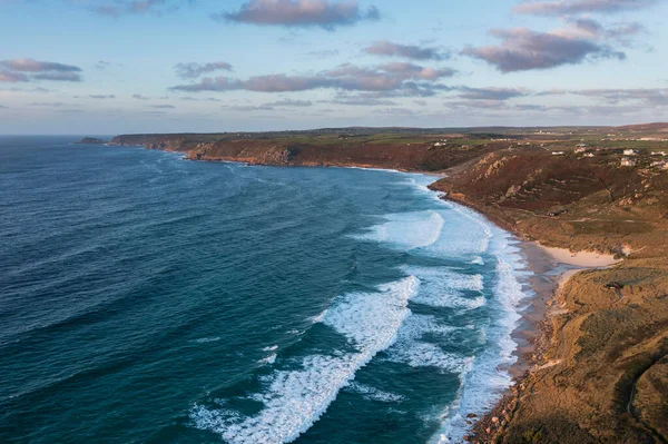 Beautiful aerial drone landscape image of Sennen Cove in Cornwall at sunset with stunning sky