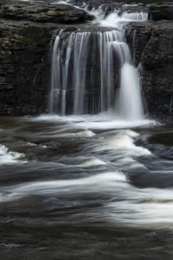 Beautiful peaceful landscape image of Aysgarth Falls in Yorkshire Dales in England during Winter morning