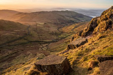 Beautiful Winter dawn landscape view from Red Screes in Lake District looking South towards Windermere with colorful vibrant sky