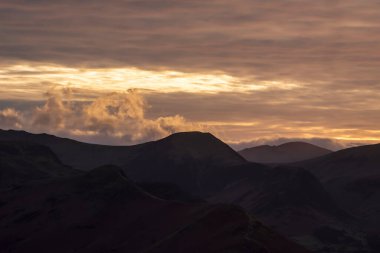 Absolutely stunning landscape image of view across Derwentwater from Latrigg Fell in lake District during Winter beautiful colorful sunset 