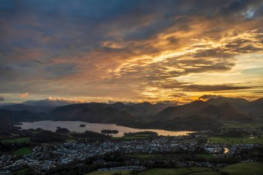 Absolutely stunning landscape image of view across Derwentwater from Latrigg Fell in lake District during Winter beautiful colorful sunset 