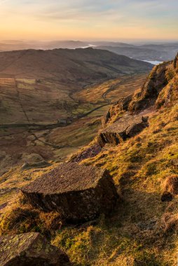 Beautiful Winter dawn landscape view from Red Screes in Lake District looking South towards Windermere with colorful vibrant sky