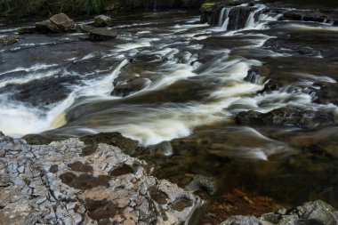 Beautiful peaceful landscape image of Aysgarth Falls in Yorkshire Dales in England during Winter morning