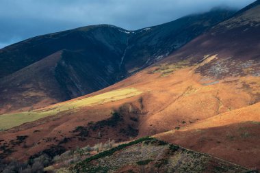 Beautiful sunrise golden hour light on the slopes of Skiddaw in the English Lake District
