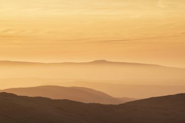 Lovely Winter landscape view from Red Screeds across misty layers of mountains Ill Bell, Stony Cove Pike and Tarn Crag