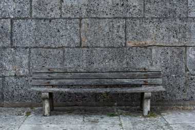 Beautiful old worn wooden bench on sea wall in Dorset clipart