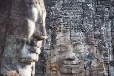 Antik Bayon tapınağının dev taş yüzleri. Bayon Tapınağı, Angkor Thom, Siem Reap, Kamboçya duvarındaki Khmer kralının taş yüzleri.