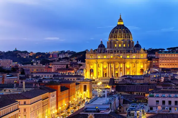 View of St. Peter\'s Basilica in the Vatican city at sunset, Rome, Italy. Saint Peter Basilica in Vatican City at Rome, Italy and Street Via della Conciliazione at sunset sky.