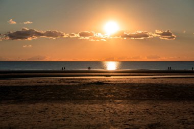 Sunset after ebb in the North Sea in Sank-Peter-Ording, Germany