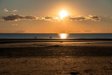 Sunset after ebb in the North Sea in Sank-Peter-Ording, Germany