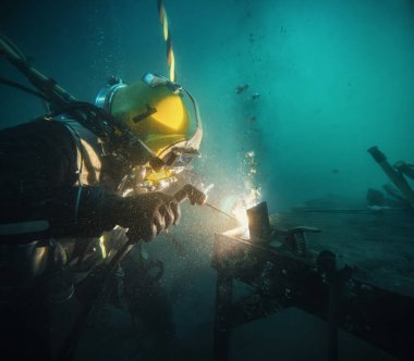 Commercial diver welding underwater at construction site clipart