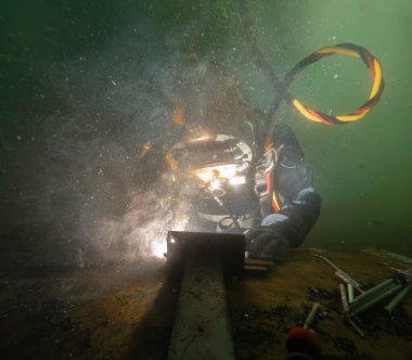 Underwater welding in deep ocean depths closeup clipart