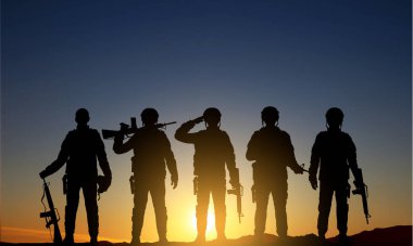 Military silhouettes of soldiers against the sunrise. EPS10 vector