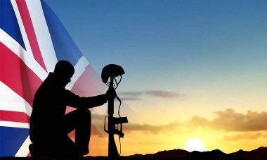 Silhouette of soldier kneeling down on background of sunset and United Kingdom flag. Background for Remembrance Day. EPS10 vector