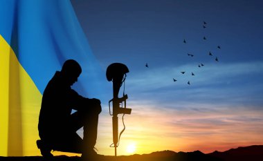 Flag of Ukraine with silhouette of soldier kneeling down against the sunset. Armed forces of Ukraine concept. EPS10 vector