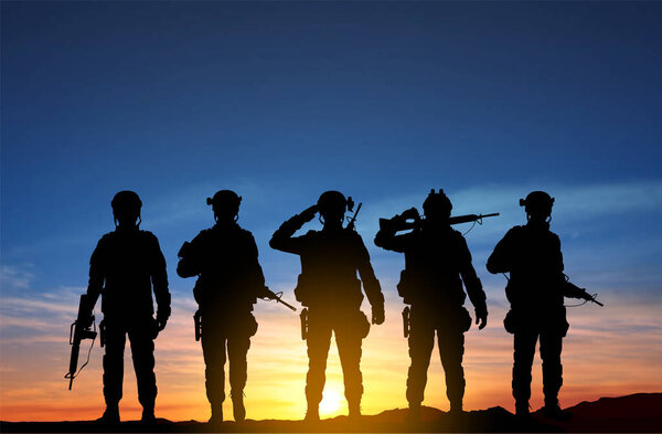 Silhouettes of a soliders against the sunset. EPS10 vector