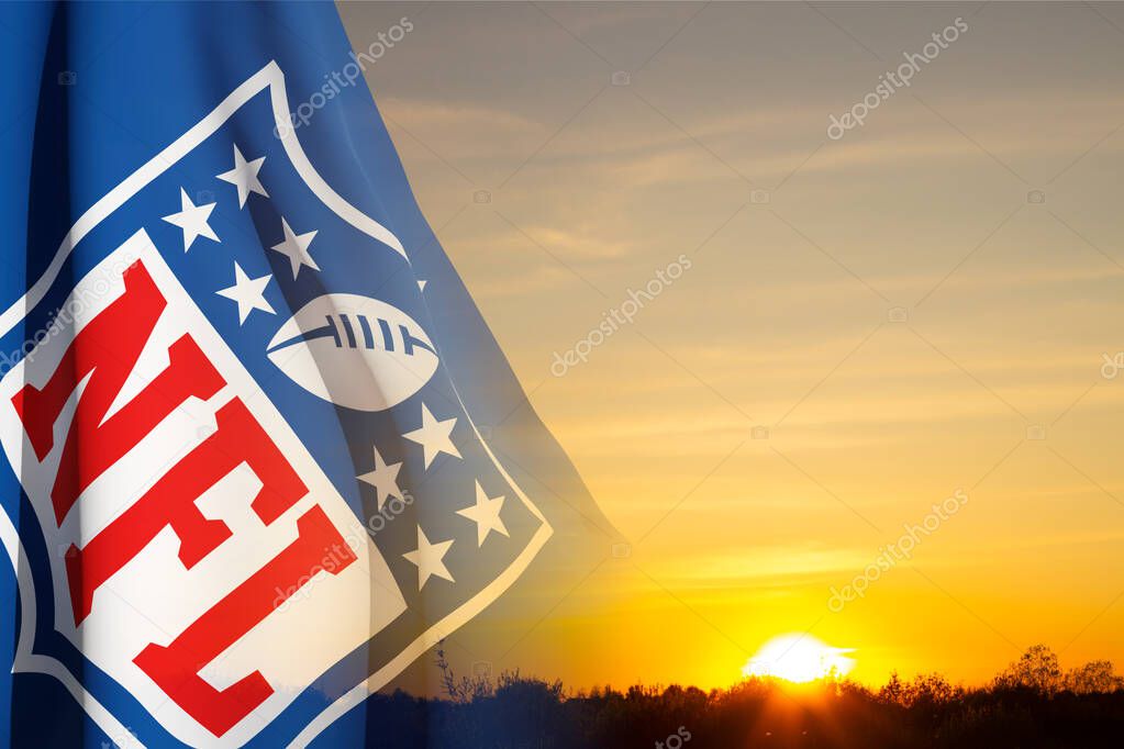 The flag with the NFL logo on background of sky. NFL is a professional American football league. Moscow, Russia - May, 2023