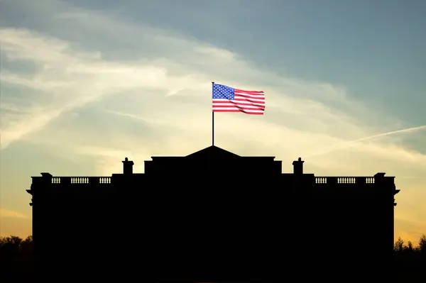 Silhouette of White House with USA flag against the sunset