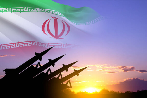 Missiles silhouettes with Iran flag against the sunset