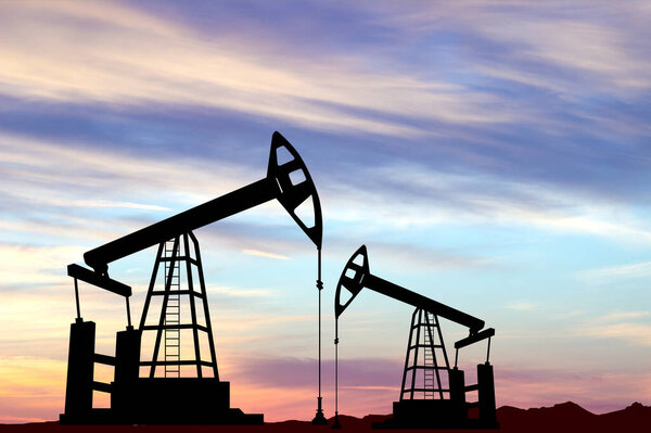 Силуэт нефтяного насоса. Промышленное оборудование для производства нефти на фоне заката