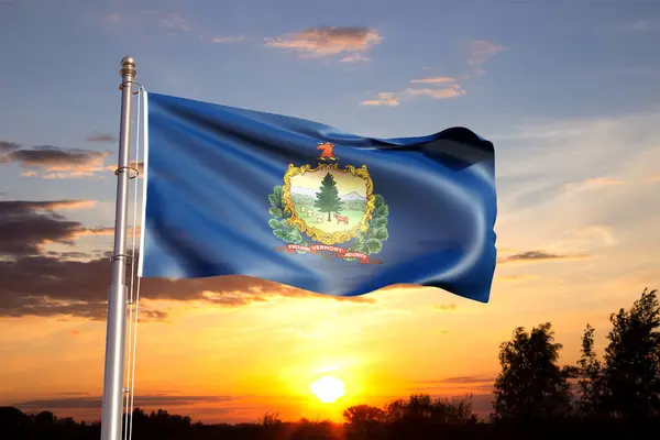 stock image Flag of Vermont against the sunset sky. US state