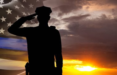 Gün batımına karşı bir polis memurunun silueti. Polis destek sembollü Amerikan bayrağı. İnce mavi çizgi. Ulusal Yasa Uygulama Günü konsepti