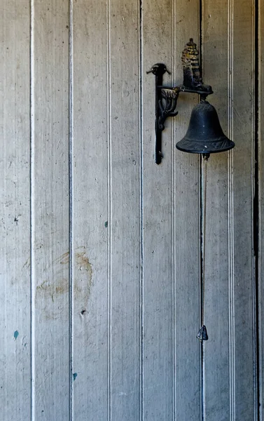 Vintage door bell on the wall of old wooden house - Castro, Chile