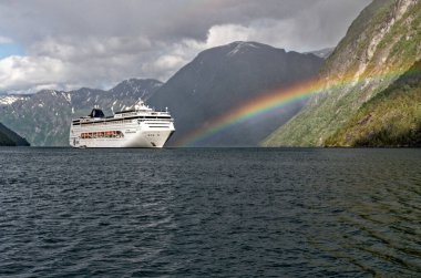 Rainbow over MSC Lirica Cruise ship in Norwegian Fjords - Geiranger fjord - Hellesylt, Sunnylvsfjord, Norway, Scandinavia. Travel destination Norway. 02.07.2012