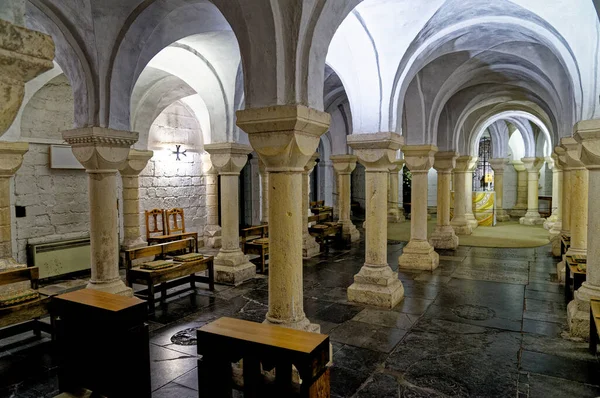 stock image Worcester Cathedral, Worcester, Worcestershire, England, United Kingdom - 28th of January 2023. Vaults under the cathedral showing several arches and columns. Flagstone floor with subdued lighting.